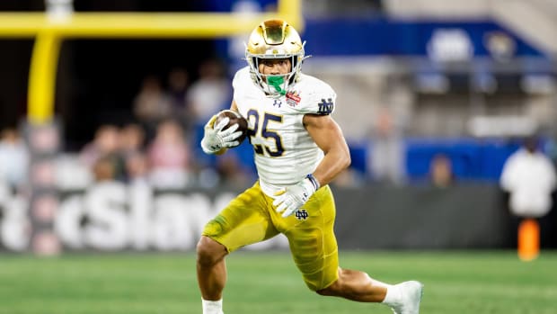 Notre Dame Fighting Irish running back Chris Tyree (25) runs with the ball during the second half against the South Carolina Gamecocks in the 2022 Gator Bowl at TIAA Bank Field.